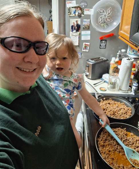 Angie helping Elizabeth cook