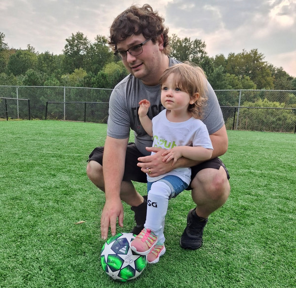 Josh teaching Angie how to play soccer